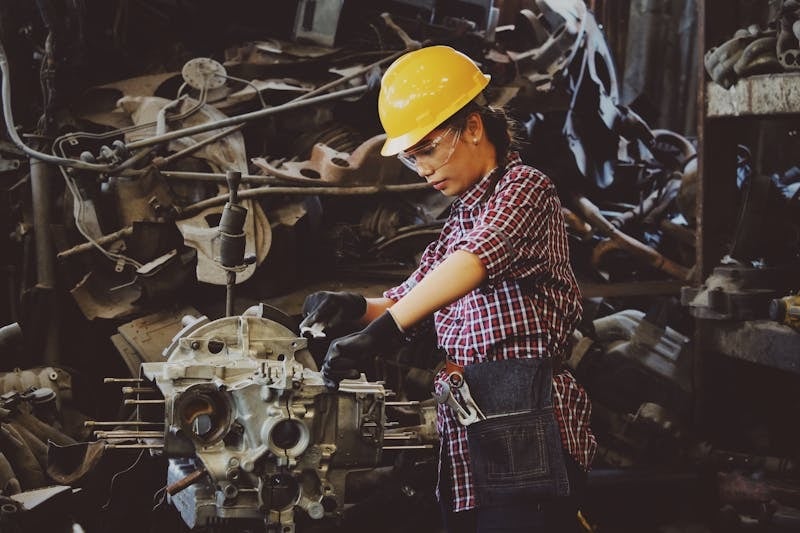 Woman working on a engine